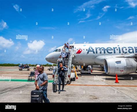 American Airlines jet preparing for takeoff at Cyril E. King Airport with Caribbean backdrop