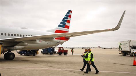 american airlines terminal with pilots walking toward aircraft