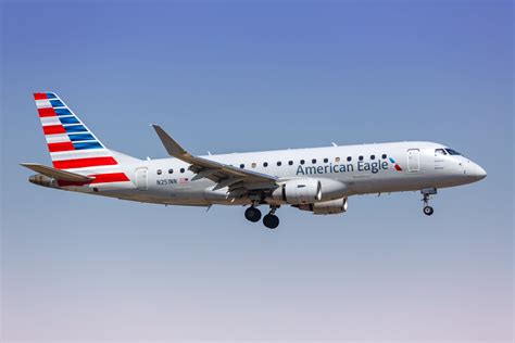 American Eagle E175 taking off from Miami International Airport with skyline in background