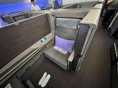 ANA First Class suite with wide leather seat and elegant finishes