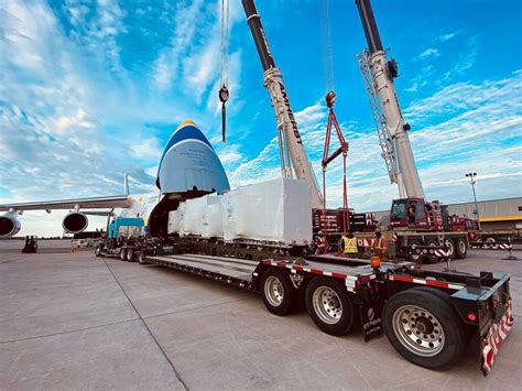 Antonov An-124 loading oversized cargo through nose door with wide wings visible