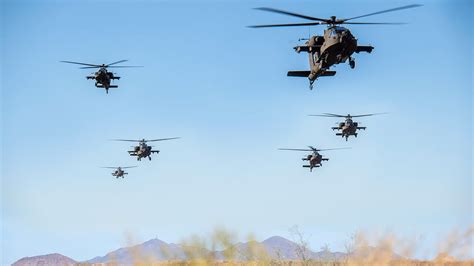 Apache helicopters flying in formation during combat exercise overseas