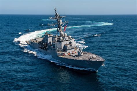 Arleigh Burke class destroyer underway at sea with radar mast