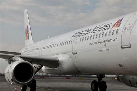 Armenian Airlines aircraft preparing for departure at night, symbolizing a new journey ahead