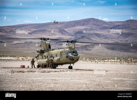 Army aviation brigade conducting maintenance on a Chinook helicopter during field operations