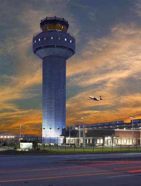 ATC tower overlooking busy intersecting runways at sunset