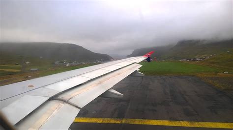 Atlantic Airways plane taking off from Vágar Airport FAE with mountains in background