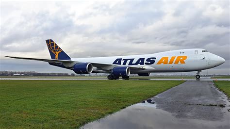 atlas air boeing 747-8f taxiing at sunrise