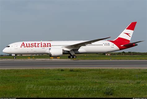 austrian airlines boeing 787-9 taking off from vienna international airport with cityscape