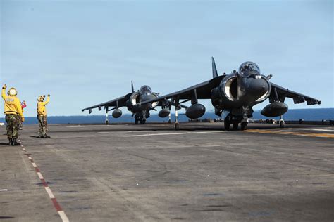 AV-8B Harrier II performing vertical landing on amphibious assault ship