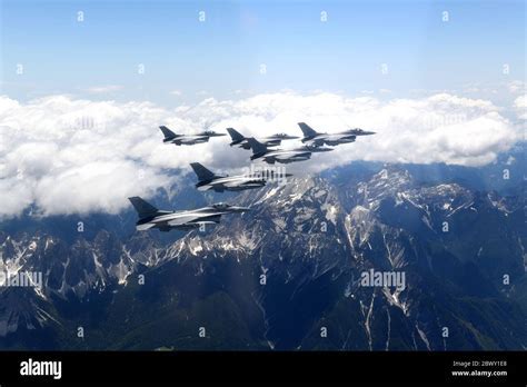 Aviano Air Base F-16 fighters with Alpine mountains backdrop