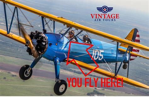 aviation club meeting in hangar with vintage aircraft in background