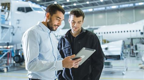 aviation management graduates at airport operations desk