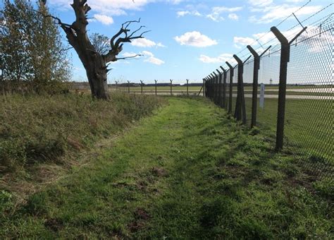 aviation photographer near military airfield perimeter fence