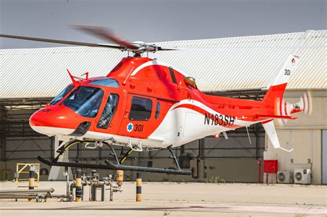 AW119Kx helicopter conducting utility flight operations in arid terrain