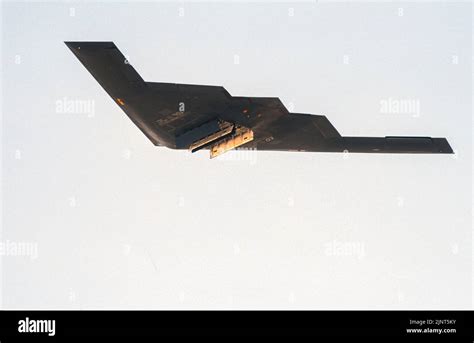 b-2 spirit flying above the pacific with bomb bay doors open mid-mission