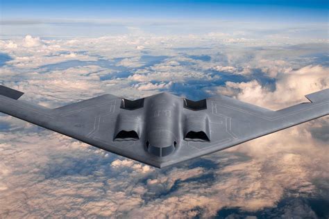 B-2 Spirit flying at sunset highlighting iconic flying wing silhouette