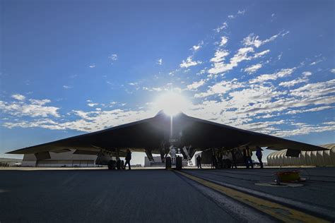 B-2 Spirit stealth bomber cruising above cloud layer at sunset