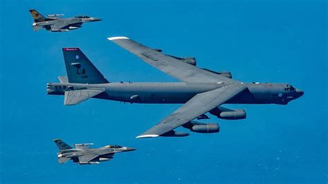 B-52 bomber takeoff with eight engines producing smoke trails