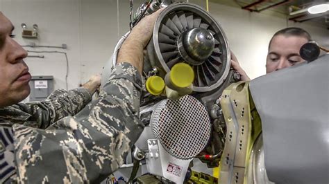 B-52 maintenance crew servicing engines on airfield
