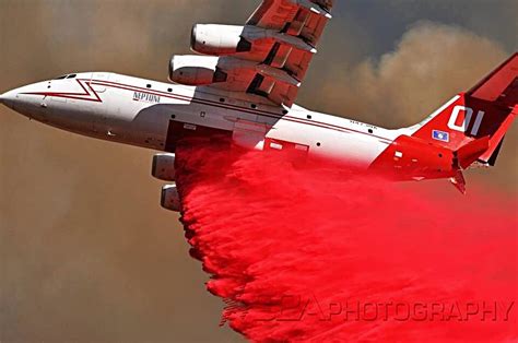 BAe-146 aerial firefighting air tanker releasing fire retardant
