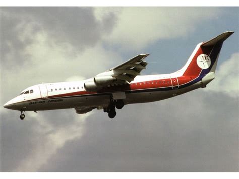 BAe-146 departing London City Airport over urban skyline