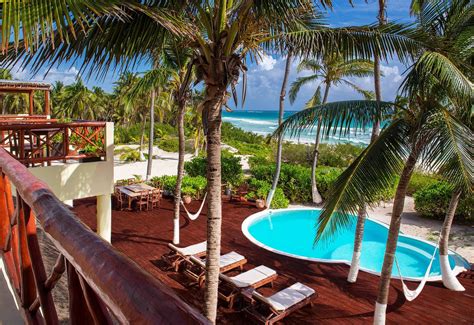 Beachfront infinity pool in Tulum, Mexico at dusk