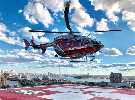 Bell 407 landing on rooftop hospital helipad in emergency medical configuration, 2024