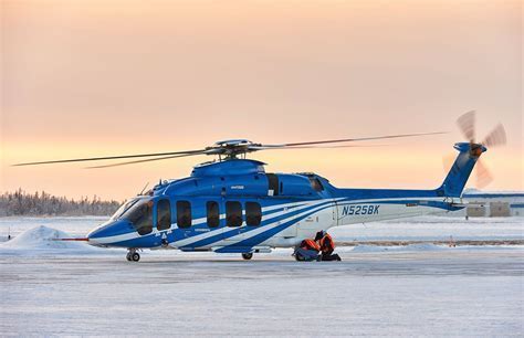bell 525 relentless at sunset on offshore helipad in north sea