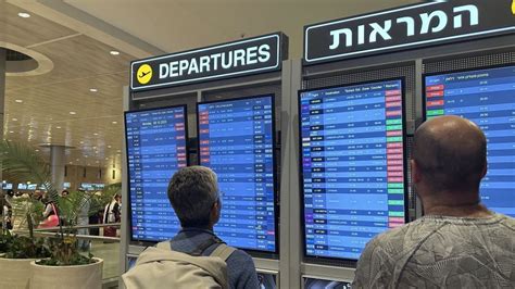 Ben Gurion Airport departures board showing flight cancellations to Tel Aviv