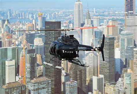 Blade helicopter departing NYC rooftop helipad at sunset