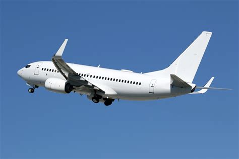 Boeing 737-700 departing high-altitude mountain airport with steep climb