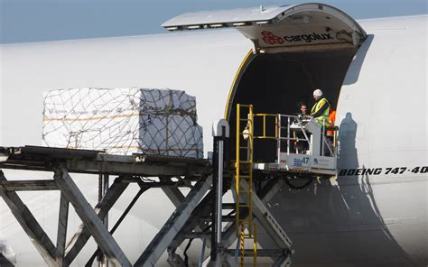 Boeing 737 aircraft loading cargo and passengers before departure with ground crew