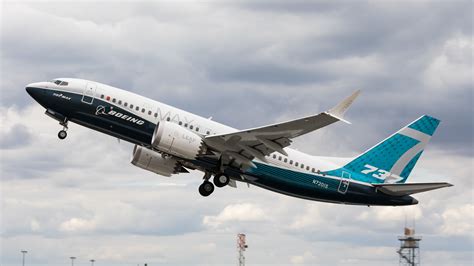 Boeing 737 MAX aircraft climbing after takeoff with airline livery clear sky
