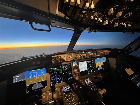 Boeing 737 MAX cockpit modern displays and split winglet visible through window