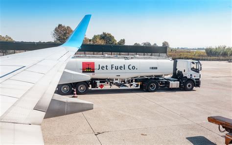 Boeing 737 refueling with jet fuel truck on airport ramp