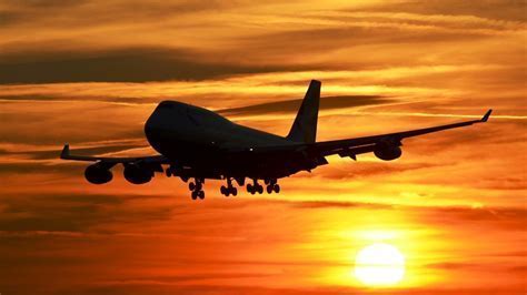 Boeing 747-100 silhouette flying against Iranian sunset