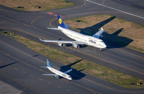 Boeing 747-8 Intercontinental taxiing with airport ground equipment