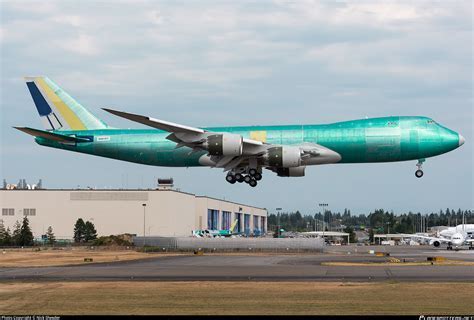 Boeing 747-8F loading cargo at twilight on tarmac