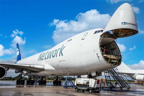 Boeing 747 cargo charter aircraft loading oversized freight at airport