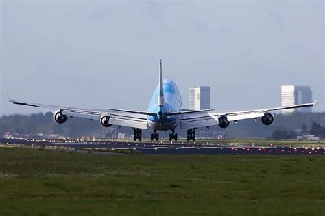 Boeing 747 executing a crosswind landing with visible wing bank and slight yaw alignment