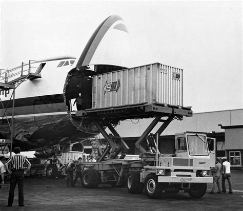 Boeing 747 freighter cargo loading through nose door at international cargo hub