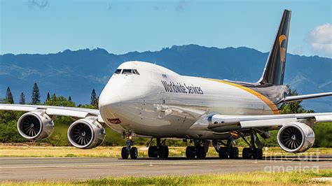 Boeing 747 freighter taxiing at major international airport, emphasizing massive wingspan