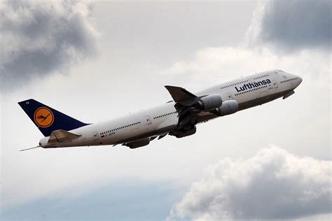 Boeing 747 jumbo jet climbing after takeoff showing iconic upper deck hump