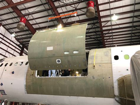 Boeing 757 freighter conversion cargo door installation and reinforced floor system