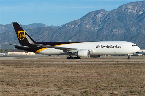 Boeing 767-300F cargo aircraft loading freight containers night operations logistics hub