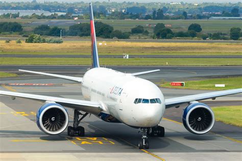 Boeing 777-200ER long haul aircraft climbing at sunset