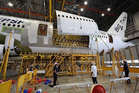 Boeing 777-300ER freighter conversion structural modification inside maintenance facility