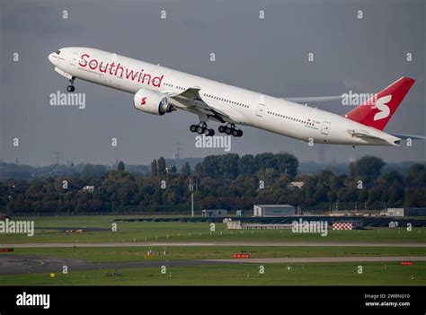Boeing 777-300ER taking off long haul sunset runway