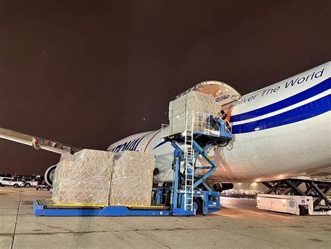 Boeing 777-8F cargo freighter loading pallets at airport